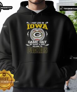 Person wearing a Green Bay Packers hoodie, showcasing pride for the team on game day, despite living in Iowa.