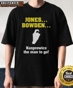 Alt Text: Hot Jones Bowden Kasprowicz The Man To Go T-Shirt displayed on a wooden surface, featuring bold graphic design.