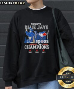 Alt Text: Toronto Blue Jays mascot sweatshirt featuring 2025 American League Champions logo and city skyline design.