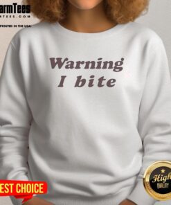 Alt Text: Nice Brooklyn wearing a 'Warning: I Bite' sweatshirt, showcasing a trendy and playful fashion statement.