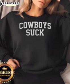 Fan wearing a 'Cowboys Suck' sweatshirt at the Chiefs vs Lions game, showcasing team spirit and sports enthusiasm.
