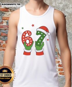 Santa Claus hands holding a festive tank top with 'Nice Christmas 67' design, perfect for holiday celebrations.