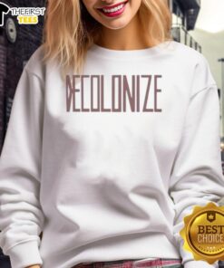 Greta Thunberg wearing a 'Decolonize' sweatshirt, promoting climate activism and social justice at a public event.