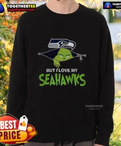 Alt Text: Cozy Grinch sweatshirt featuring 'I Hate People But I Love My Seattle Seahawks' for festive football fans.