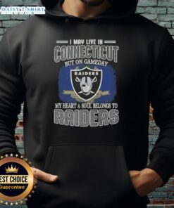 Connecticut fan wearing a Raiders hoodie, showcasing loyalty on game day with team pride and spirit.