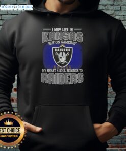 Fan wearing a Raiders hoodie, showcasing pride with the caption 'I May Live In Kansas, But My Heart Belongs To Raiders'.
