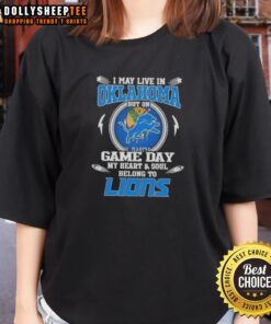 Alt Text: Ladies tee featuring 'I May Live In Oklahoma But My Heart Belongs To Detroit Lions' for game day enthusiasm.
