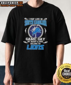 Alt Text: Detroit Lions T-shirt design with text 'Nice I May Live In South Carolina But On Game Day My Heart Belongs To Detroit.'