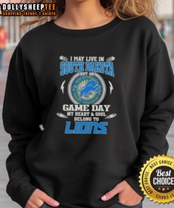 Cozy sweatshirt featuring 'I May Live In South Dakota But On Game Day My Heart Belongs To Detroit Lions' design.