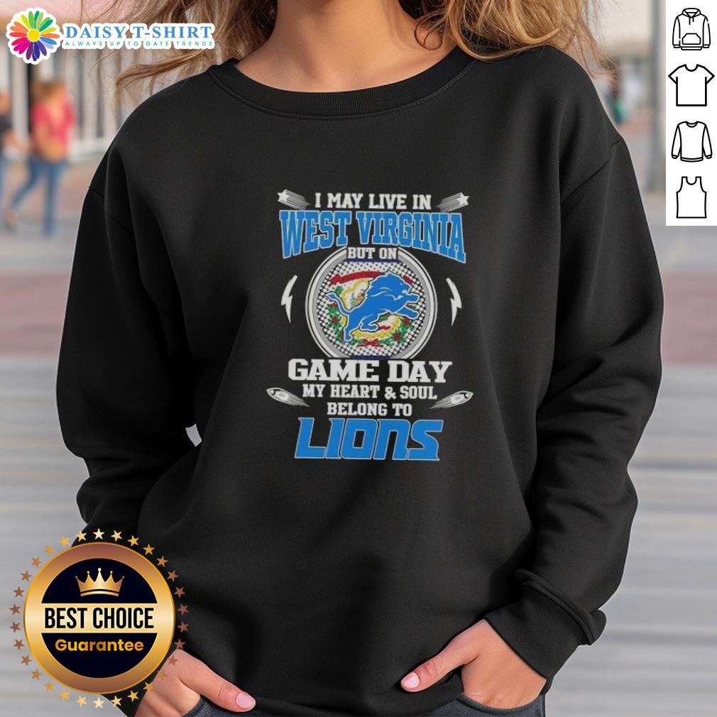 Nice I May Live In West Virginia But On Game Day My Heart And Soul Belongs To Detroit Lions Sweatshirt Alt Text: Cozy sweatshirt reading I May Live In West Virginia But On Game Day My Heart Belongs To Detroit Lions