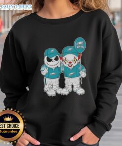 Happy Halloween sweatshirt featuring Jack Skellington and Clown It with Philadelphia Eagles logo, perfect for fans.