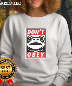 Colorful Nice Portland Frog sweatshirt featuring bold text: 'Demand That You Dont Obey' for unique fashion statement.