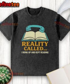 Alt Text: Person wearing a 'Hung Up And Kept Reading' washed t-shirt, immersed in a book in a cozy setting.