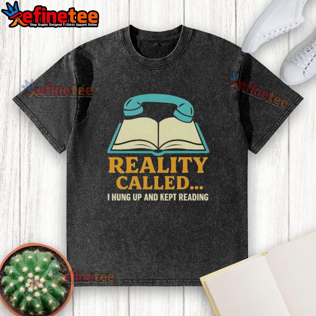 nice-reality-called-i-hung-up-and-kept-reading-book-washed-t-shirt Alt Text: Person wearing a 'Hung Up And Kept Reading' washed t-shirt, immersed in a book in a cozy setting.