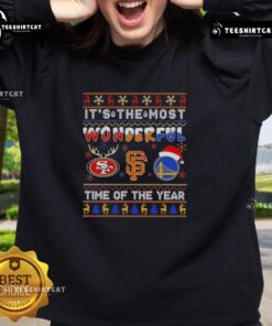 Alt Text: Cozy sweatshirt featuring San Francisco 49ers, Giants, and Warriors logos, perfect for Christmas celebrations.