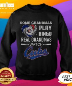 Grandmas wearing 'Real Grandmas Watch Cubs' sweatshirt enjoy bingo at a Chicago Cubs baseball game, showcasing team spirit.
