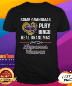 Grandmas wearing 'Real Grandmas Watch Minnesota Vikings Football' T-shirt enjoy bingo night with friends in a cozy setting.