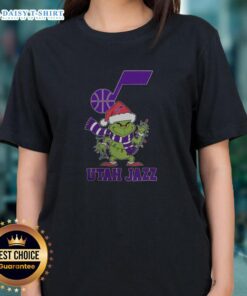 Utah Jazz Christmas tee for ladies featuring Grinch and Santa hat design, perfect for holiday 2025 celebrations.