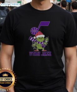 Alt Text: Utah Jazz Christmas Grinch Santa Hat Holiday 2025 T-Shirt featuring festive graphics and team colors for basketball fans.