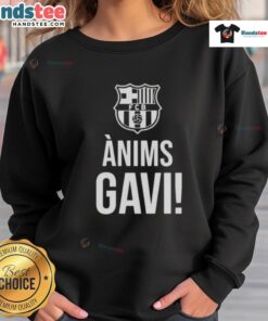 Alt Text: Official Barcelona Anims Gavi Support 2025 Sweatshirt in blue, featuring team logo and player graphics.