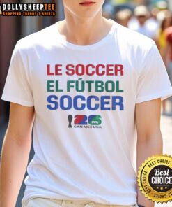 Official FIFA World Cup 2026 T-shirt featuring 'Mex, USA, Le Soccer, El Futbol' in vibrant colors for soccer fans.