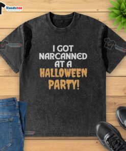 Official 'I Got Narcanned at a Halloween Party' washed t-shirt displayed on a wooden surface, showcasing vibrant graphics.