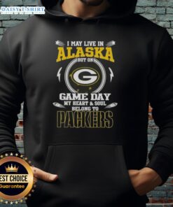 Green Bay Packers hoodie with 'I May Live In Alaska, But On Game Day, My Heart And Soul Belongs To' text design.