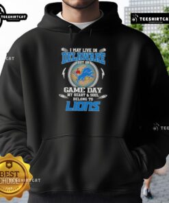 Official I May Live In Delaware But On Game Day My Heart And Soul Belongs To Detroit Lions Hoodie displayed on a hanger.