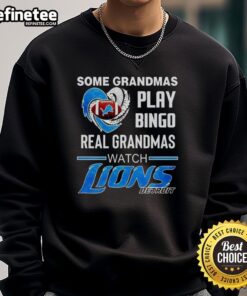 Alt Text: Official sweatshirt reading 'Some Grandmas Play Bingo, Real Grandmas Watch Detroit Lions Football' NFL apparel.