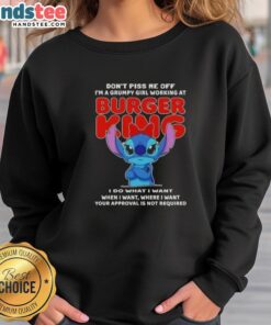 Grumpy girl in a Burger King sweatshirt with 'Don't Piss Me Off' design, showcasing official Stitch merchandise.