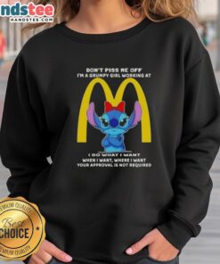 Alt Text: Grumpy girl wearing an Official Stitch Don't Piss Me Off I'm A Grumpy Girl Working At McDonald's sweatshirt.