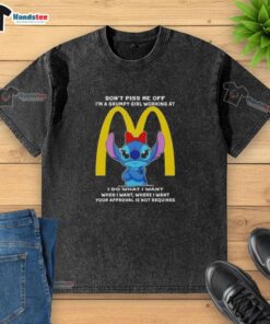 Grumpy girl in a McDonald's uniform wearing a washed 'Don't Piss Me Off' Stitch t-shirt, showcasing her playful attitude.