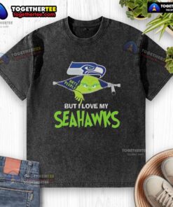 Alt Text: Original Grinch Christmas design on a washed t-shirt featuring Seahawks colors, perfect for Seattle Seahawks fans.
