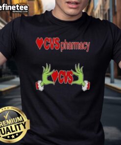 Original Grinch hands holding a heart on a CVS Pharmacy Christmas T-shirt, perfect for festive holiday cheer.