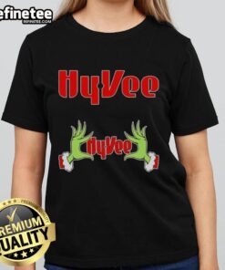 Original Grinch hands holding a heart on a Hy-Vee Christmas ladies tee, perfect for festive holiday celebrations.