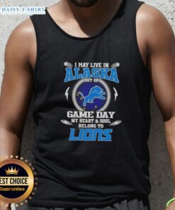 Woman wearing a Detroit Lions tank top with the phrase 'I May Live In Alaska But On Game Day My Heart Belongs To Detroit Lions'.