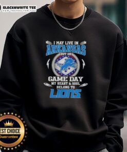 Alt Text: Cozy sweatshirt featuring I May Live In Arkansas But On Game Day My Heart And Soul Belongs To Detroit Lions design.