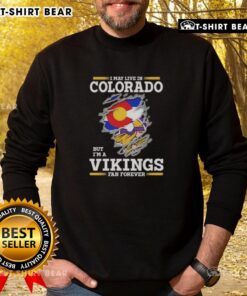 Alt Text: Cozy sweatshirt featuring I May Live In Colorado But I'm A Minnesota Vikings Fan Forever design, perfect for fans.
