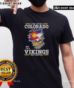 Alt Text: Original I May Live In Colorado But I'M A Minnesota Vikings Fan Forever T-Shirt showcasing team spirit and pride.