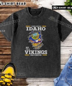 Original I May Live in Idaho But I'm a Minnesota Vikings Fan Forever washed t-shirt displayed on a rustic background.