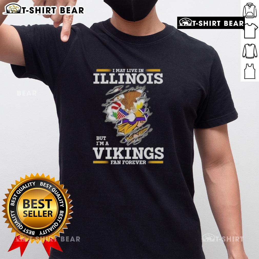 Original I May Live In Illinois But I'M A Minnesota Vikings Fan Forever T Shirt Alt Text: Original I May Live In Illinois But I'M A Minnesota Vikings Fan Forever T-Shirt design with team colors and logo.