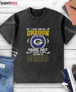 Alt Text: Washed t-shirt displaying 'I May Live In Oregon But On Game Day My Heart Belongs To Green Bay Packers' slogan.