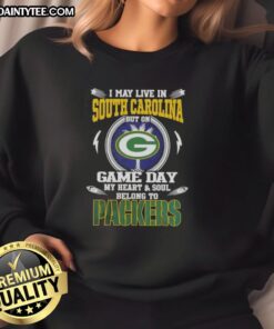 Alt Text: Cozy sweatshirt featuring 'I May Live In South Carolina But On Game Day My Heart Belongs To Green Bay Packers' design.