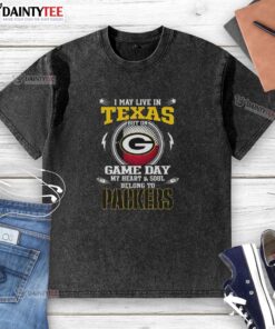 Alt Text: Washed t-shirt featuring 'I May Live In Texas But On Game Day My Heart Belongs To Green Bay Packers' design.