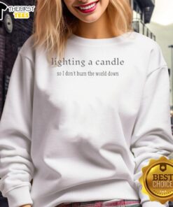 Cozy sweatshirt featuring 'Lighting A Candle So I Don't Burn The World Down' design, perfect for casual wear.