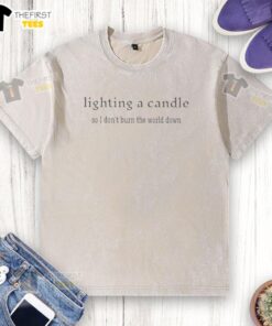 Alt Text: Original Lighting A Candle So I Don't Burn The World Down washed t-shirt featuring a unique candle graphic design.