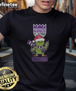 Original Sacramento Kings Christmas Grinch Santa Hat Holiday 2025 T-Shirt featuring festive design and team logo.