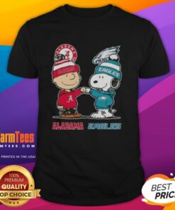 Premium Charlie Brown and Snoopy Alabama Crimson Tide x Philadelphia Eagles T-shirt featuring cartoon graphics and team logos.
