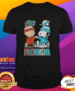 Premium Charlie Brown and Snoopy Florida Gators Miami Dolphins skyline t-shirt featuring iconic characters and vibrant design.