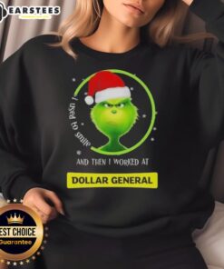 Premium Grinch Christmas sweatshirt featuring 'I Used To Smile And Then I Worked At Dollar General' design.